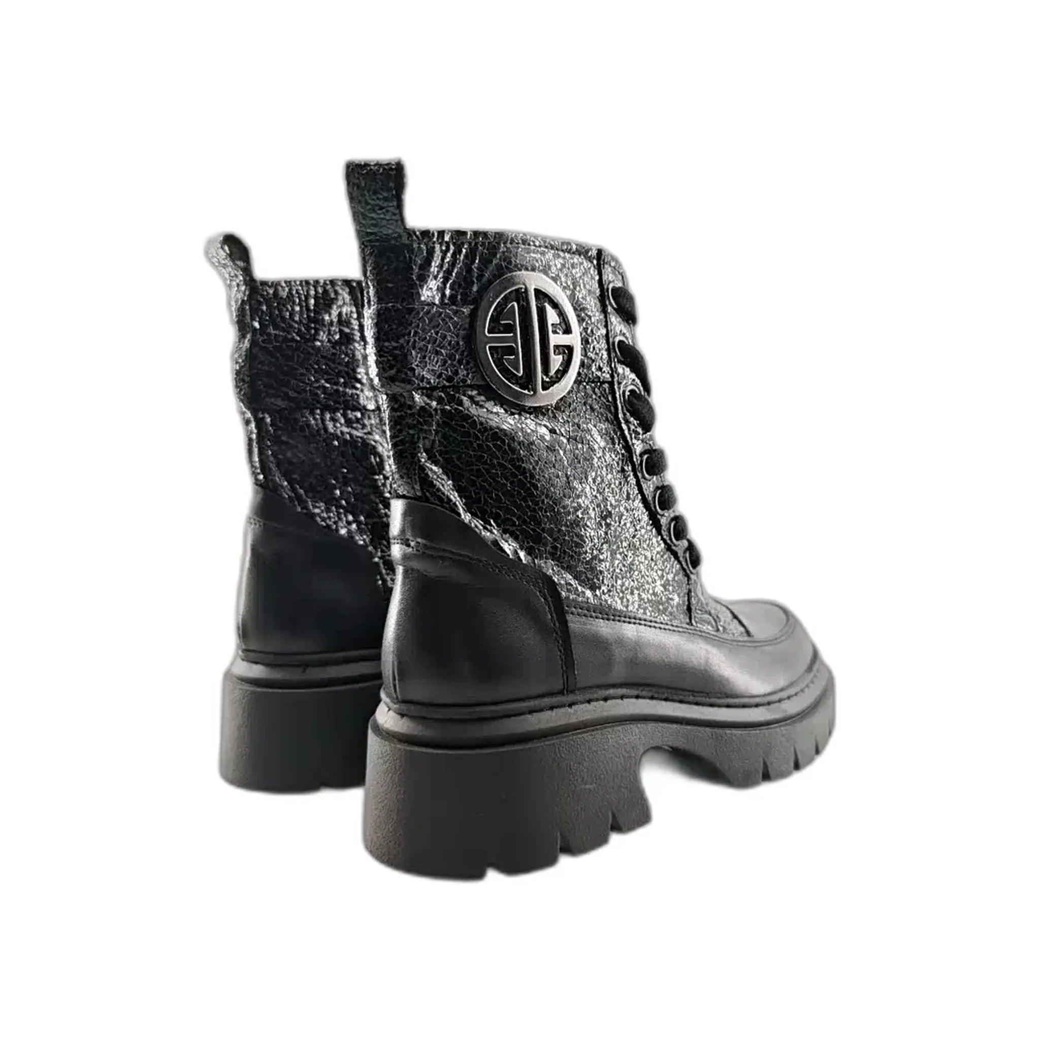 Pair of black textured leather Martin boots with thick lug soles and polished round logo emblem