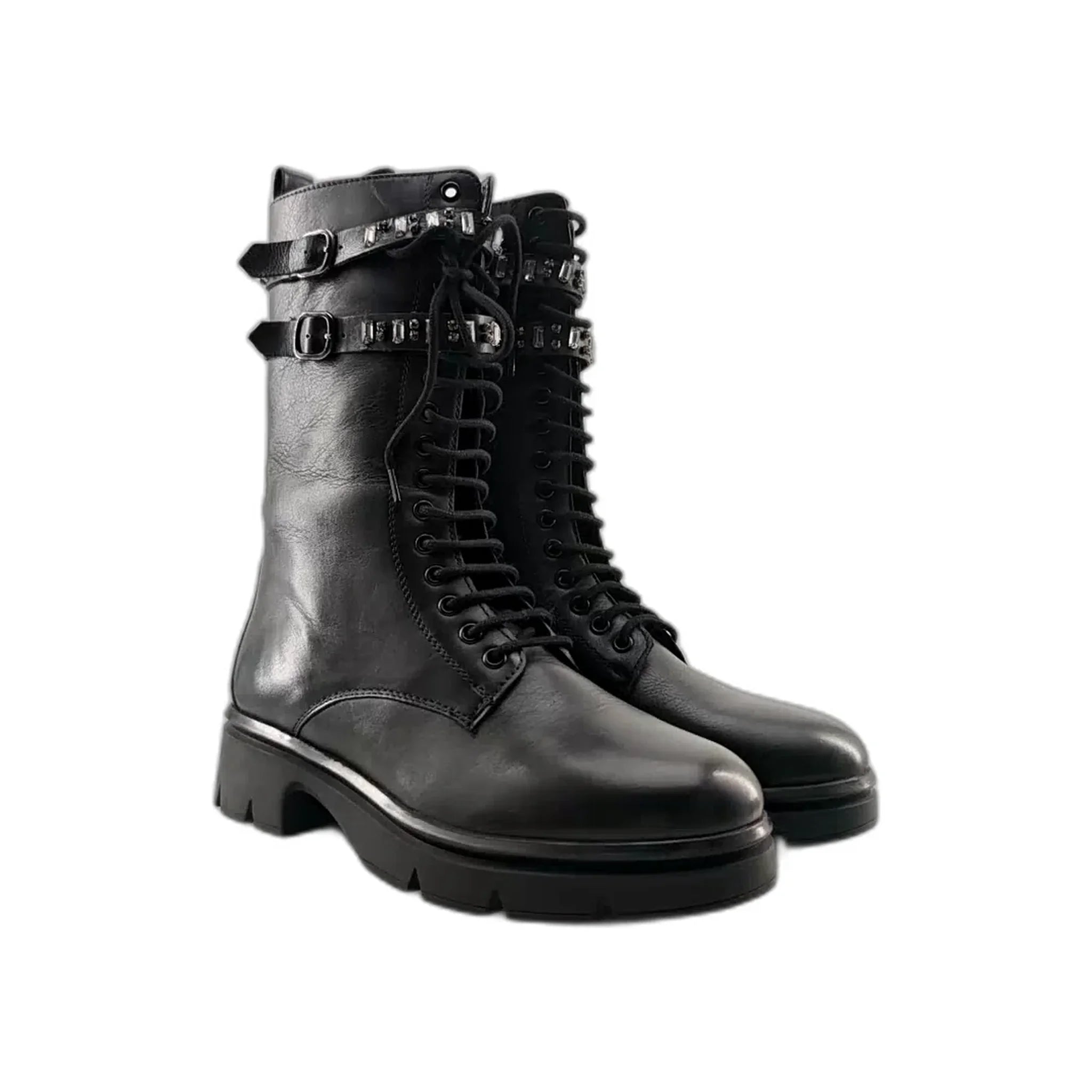 Pair of black leather combat boots with laces, buckles, and studded straps on white background